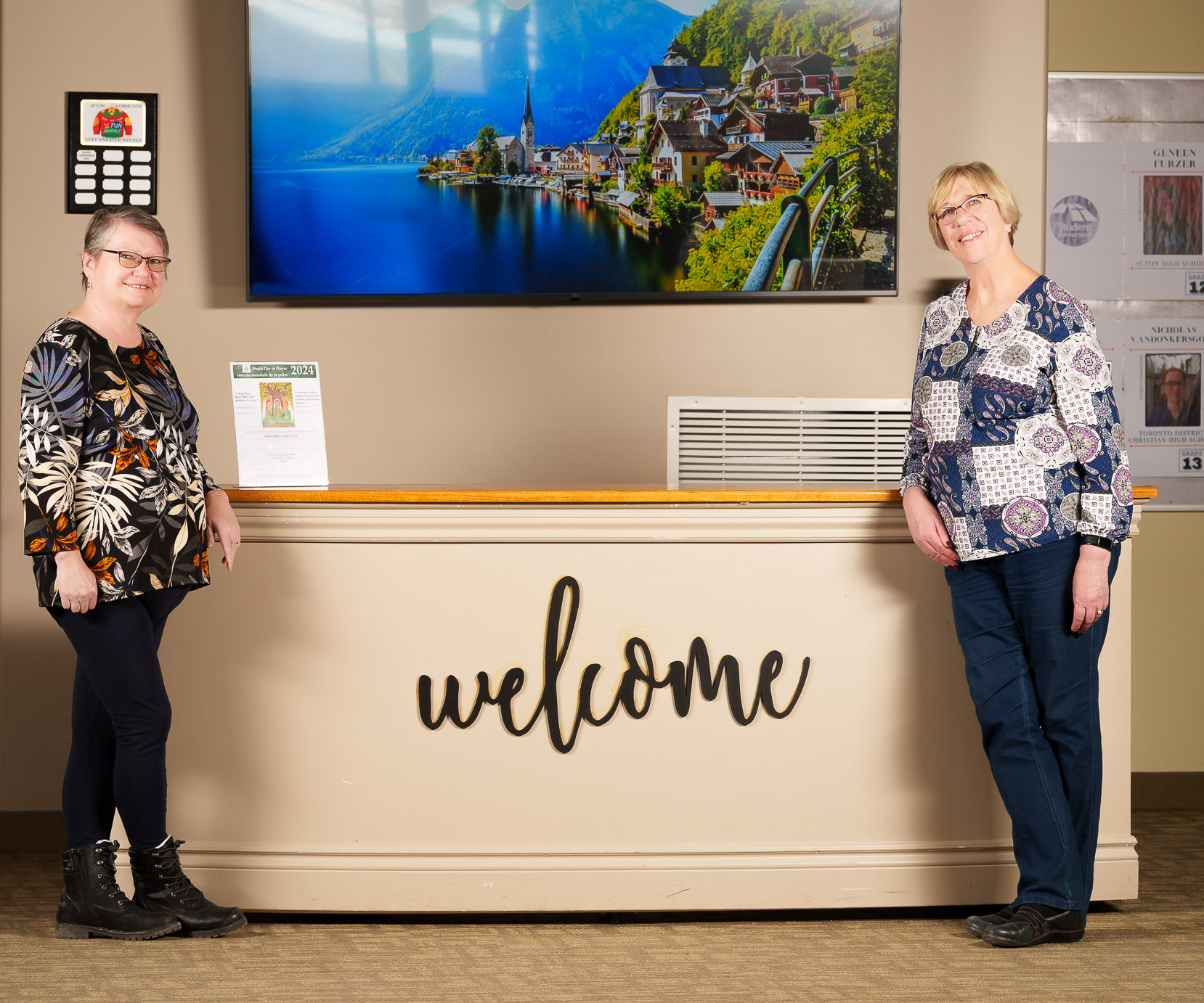 Two ladies standing in front of the welcome centre in the church